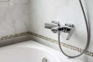 part of bathtub with shower tap in bathroom