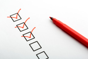 Check boxes and pen on white background